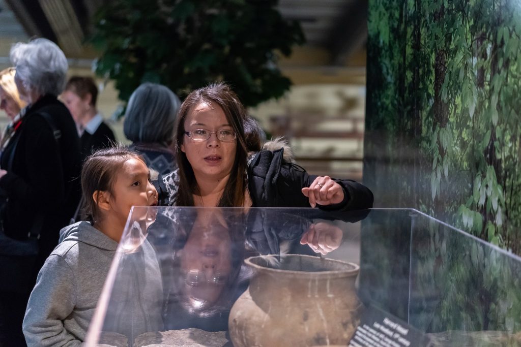 photo of mother and daughter looking at exhibit