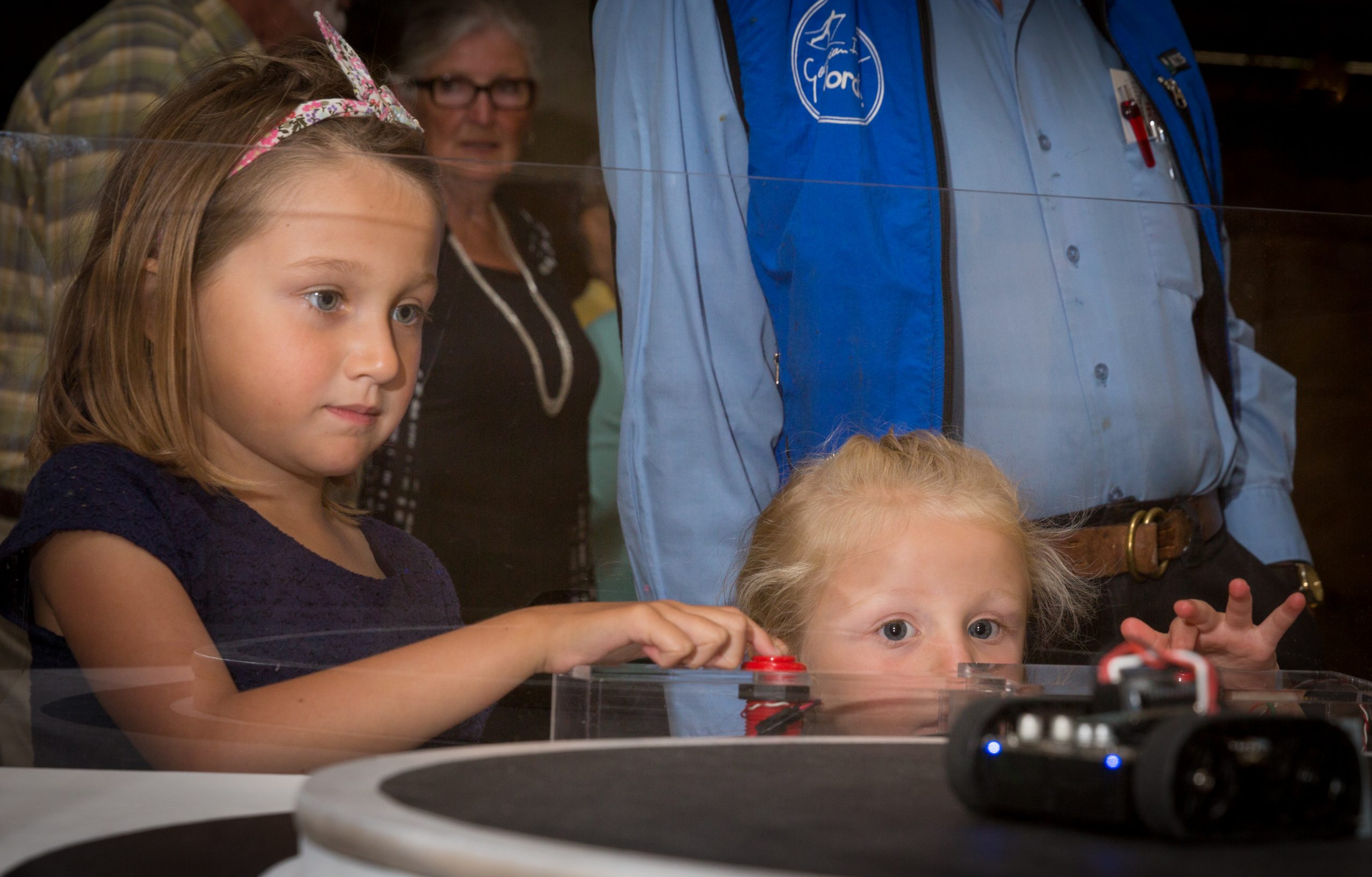image of two girls watching robots