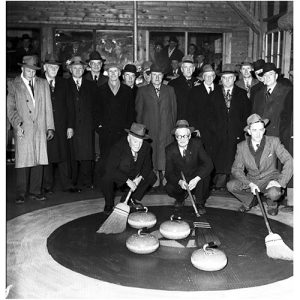 Curlers with brooms on ice