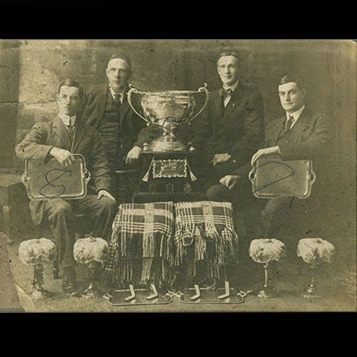 Men with trophy and other prizes