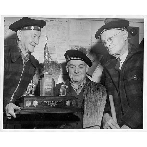 Three men with trophy