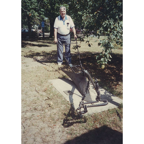 Man standing with plough