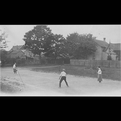 Three people playing tennis