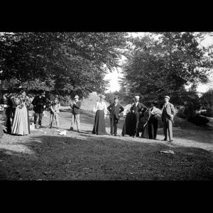 People posing with golf clubs