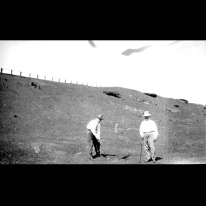 Two men playing golf