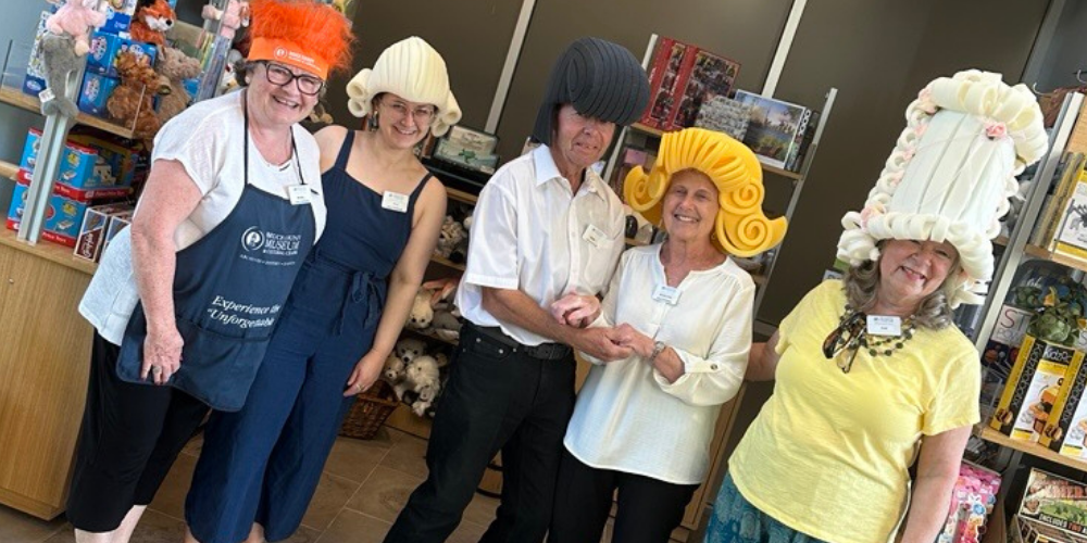 Volunteers pose with foam wigs