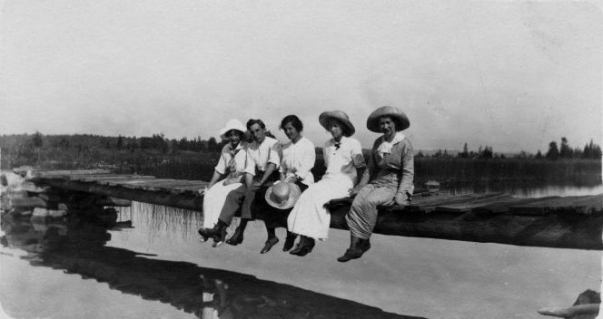 Five women on a fence